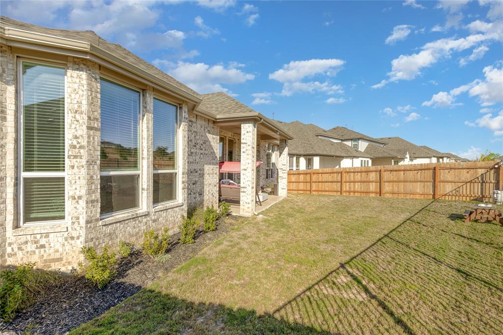 916 Willie Rnch Way Leander, TX 78641 - Photo 15 of 38 The property features a brick exterior with large windows, a covered patio, and a spacious yard