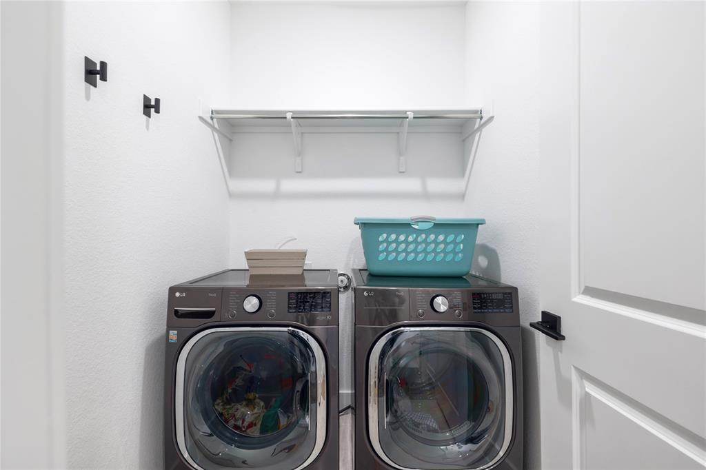 916 Willie Rnch Way Leander, TX 78641 - Photo 2 of 38 Dedicated laundry area featuring a shelf, wall-mounted hooks, and a paneled door