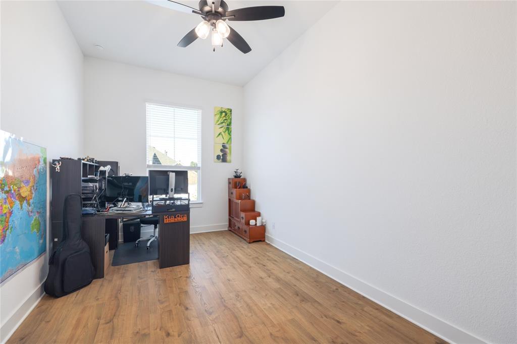 916 Willie Rnch Way Leander, TX 78641 - Photo 21 of 38 This room features wood flooring, a ceiling fan, and a window with blinds providing natural light