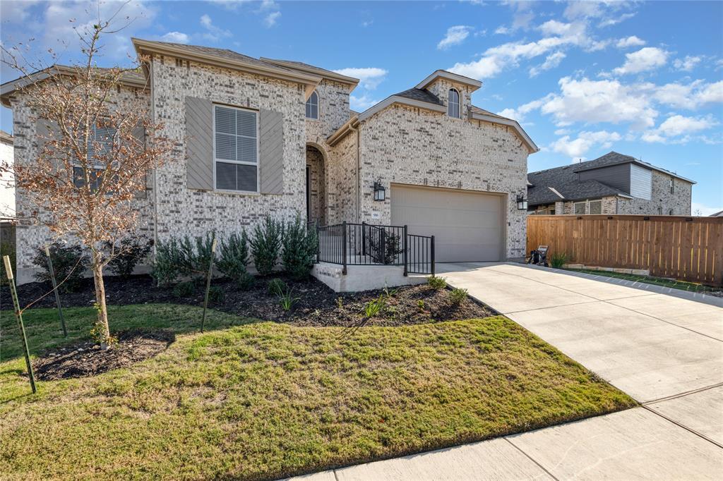 916 Willie Rnch Way Leander, TX 78641 - Photo 30 of 38 The property features an attractive light-colored brick exterior with a grey garage door and coordinating shutters