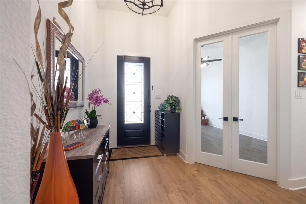 916 Willie Rnch Way Leander, TX 78641 - Photo 5 of 38 Entryway featuring light wood flooring, a decorative front door with frosted glass panels, and white walls