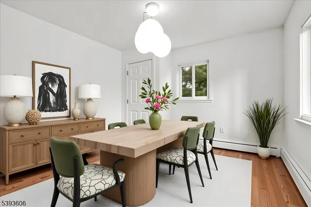 a dining room with furniture and wooden floor