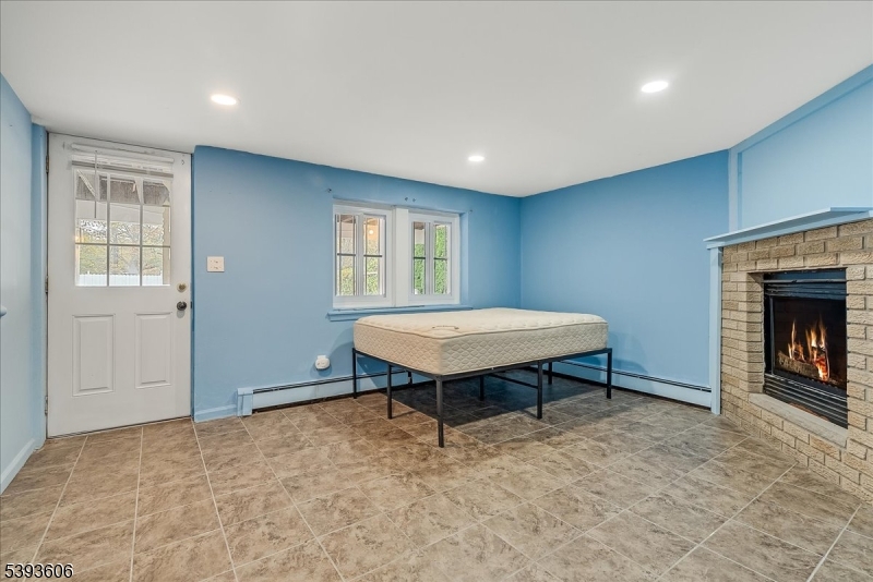 60 Kenvil Avenue Succasunna, NJ 07876 - Photo 22 of 28 a living room with pool table and a fireplace