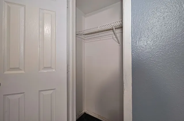 a view of an empty room and window a ceiling fan