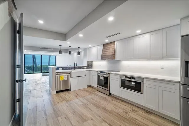 a kitchen with stove a sink and refrigerator