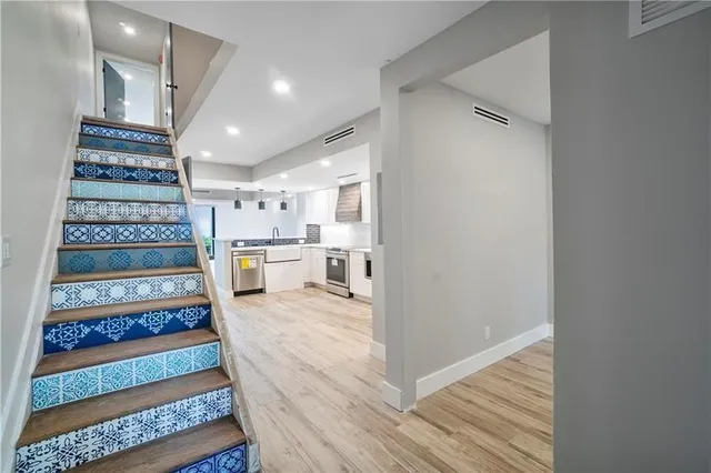 a view of entryway and hall with wooden floor
