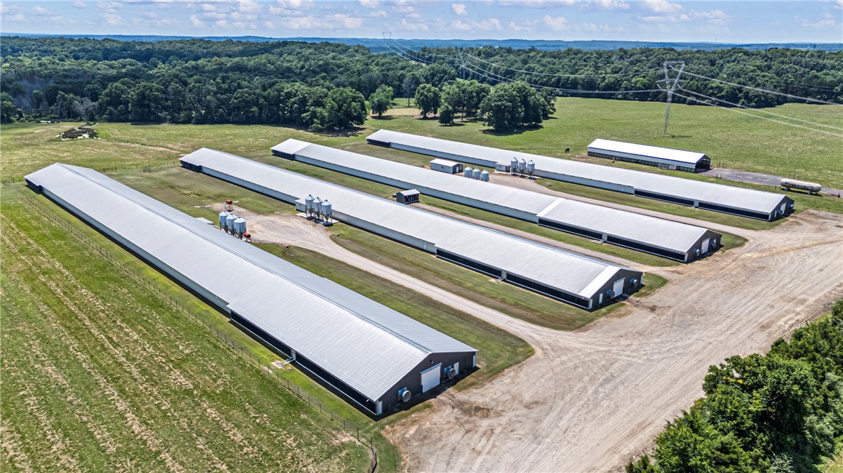 276 Charton Road Morrilton, AR 72110 - Photo 3 of 37 Multiple long structures with metal roofs situated on a large parcel of land