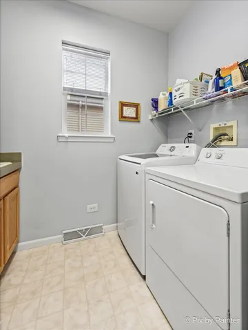 a kitchen with granite countertop a sink cabinets stainless steel appliances and a window