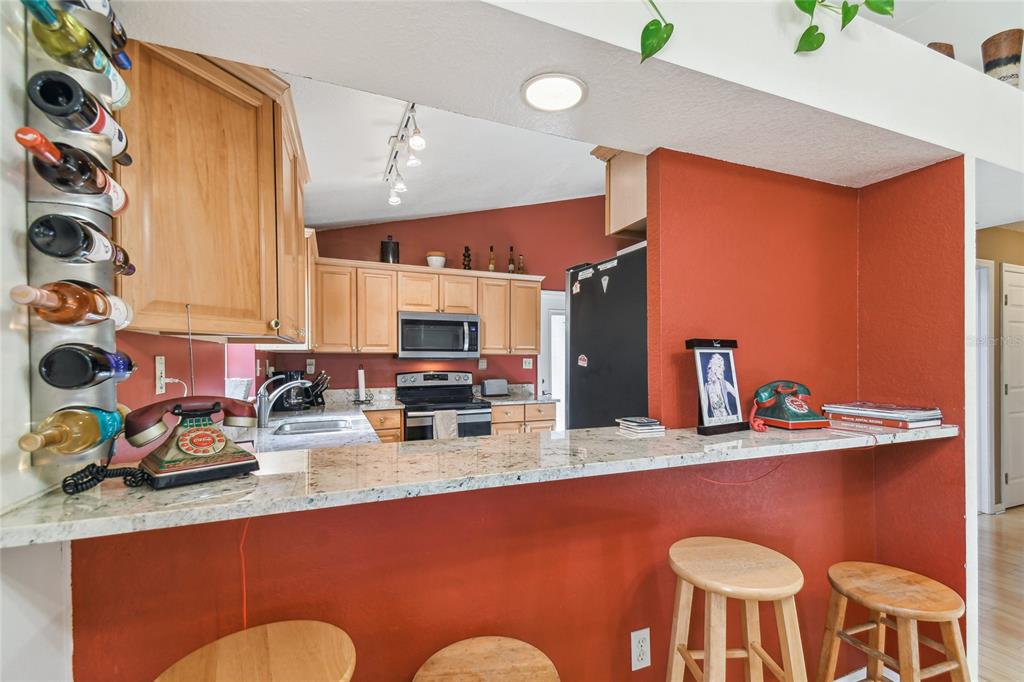 5908 Mohr Road Tampa, FL 33615 - Photo 27 of 34 a kitchen with stainless steel appliances granite countertop a sink a stove and a refrigerator