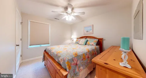 a bedroom with two beds and a chandelier