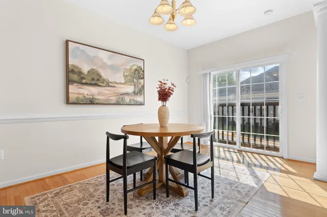 a living room with furniture a chandelier and a table