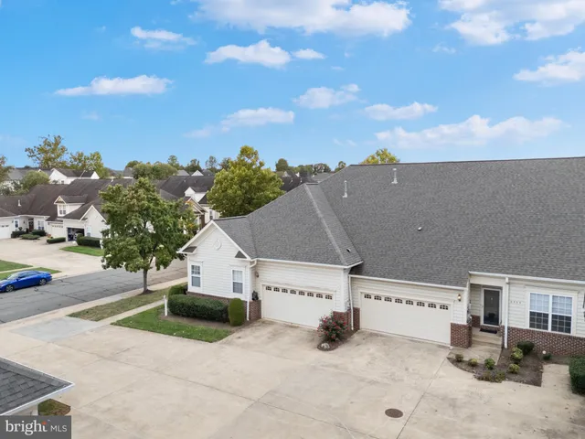 an aerial view of a house with a yard and garage