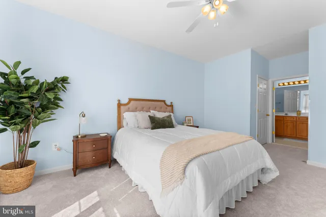 a spacious bedroom with a bed and a window