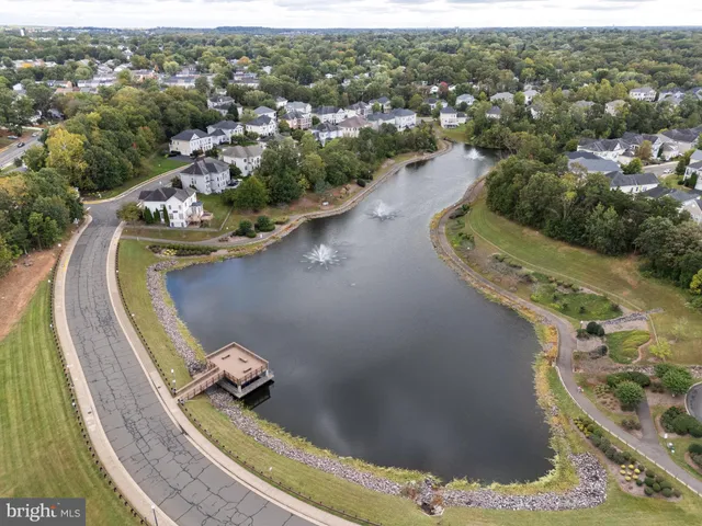 an aerial view of residential houses with outdoor space and parking