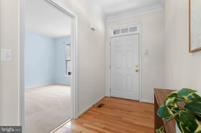 a hallway with wooden floor and furniture