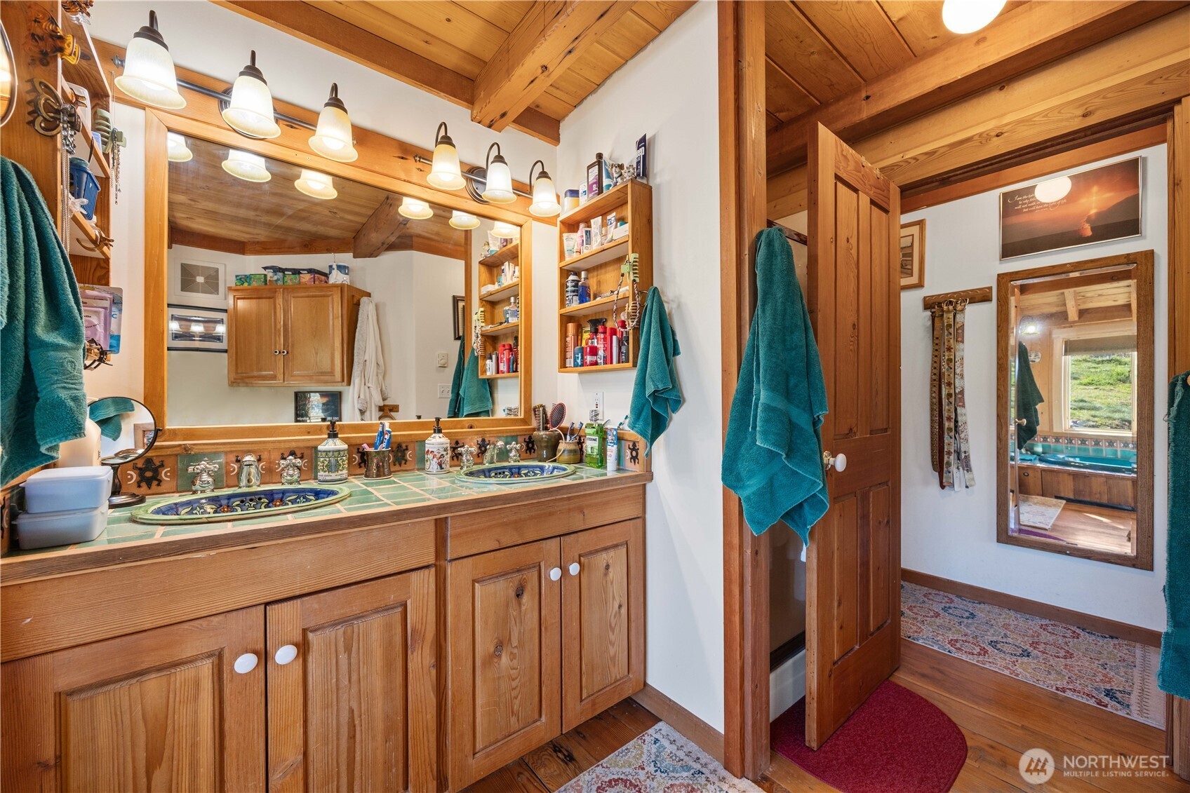 16495 South Lakeshore Road Chelan, WA 98816 - Photo 16 of 40 a bathroom with a sink a mirror and a shower
