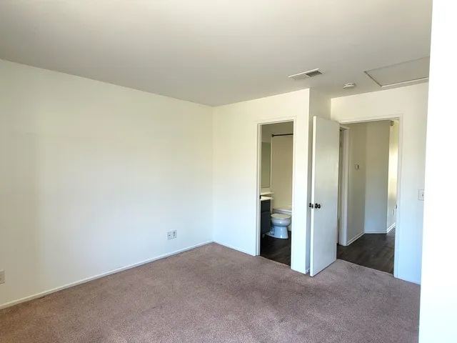 a view of a room with wooden floor and a sink