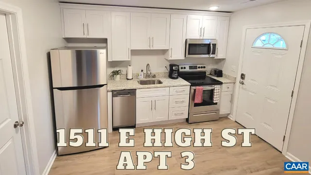 a kitchen with stainless steel appliances granite countertop a refrigerator a stove a sink and a microwave