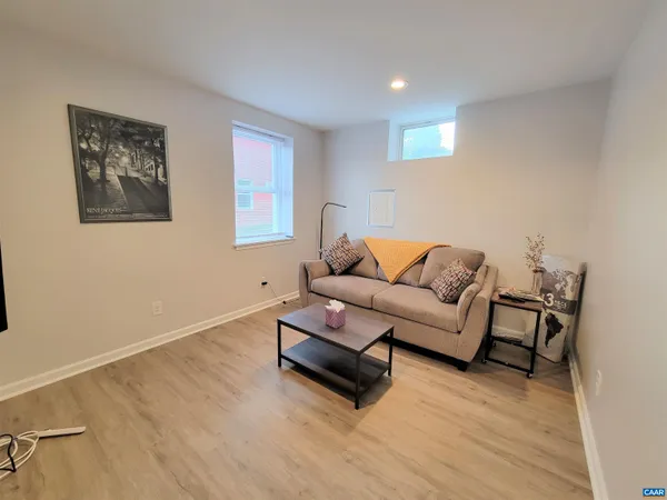 a living room with furniture and a wooden floor
