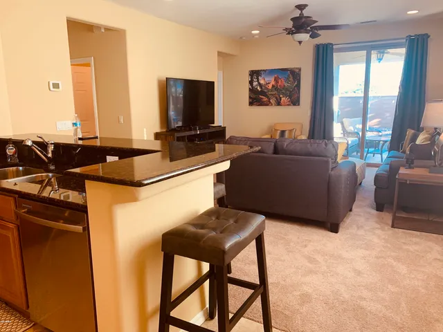 a kitchen with stainless steel appliances granite countertop a stove a sink and a microwave