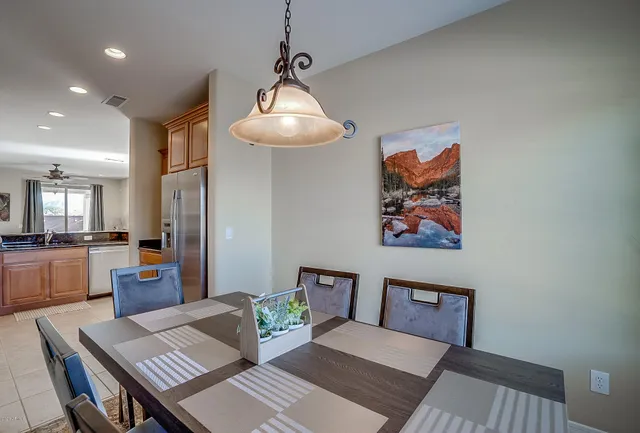 a kitchen with stainless steel appliances granite countertop a refrigerator a stove and a sink