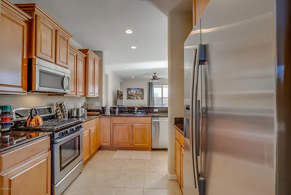 a kitchen with stainless steel appliances granite countertop a stove and cabinets