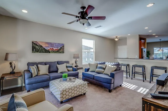 a living room with furniture and a chandelier