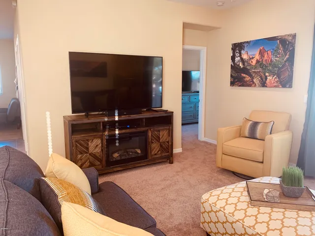 a bedroom with a bed and a flat screen tv