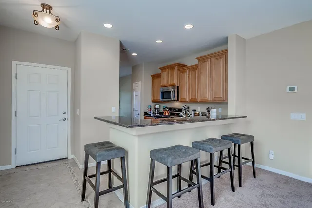 a kitchen with stainless steel appliances a stove a sink a stove and cabinets