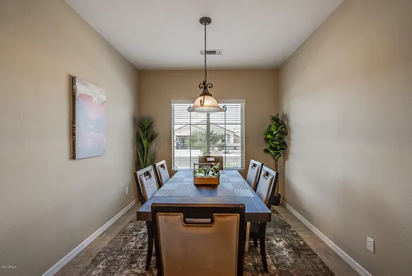 a bedroom with a bed a couch and a chandelier