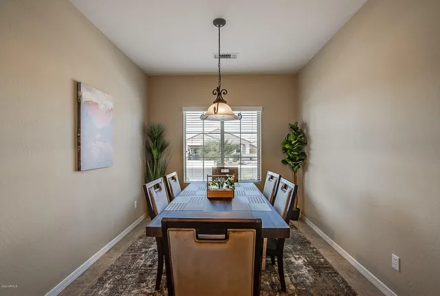 a bedroom with a bed a couch and a chandelier