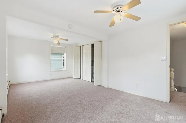 a view of empty room with ceiling fan