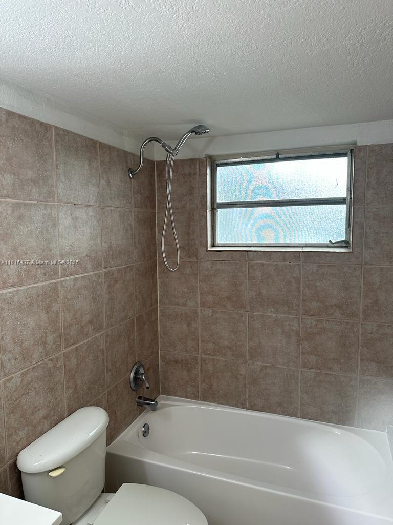 2607 Northeast 8th Avenue, Unit 19 Wilton Manors, FL 33334 - Photo 11 of 11 a bathroom with a toilet and a bathtub