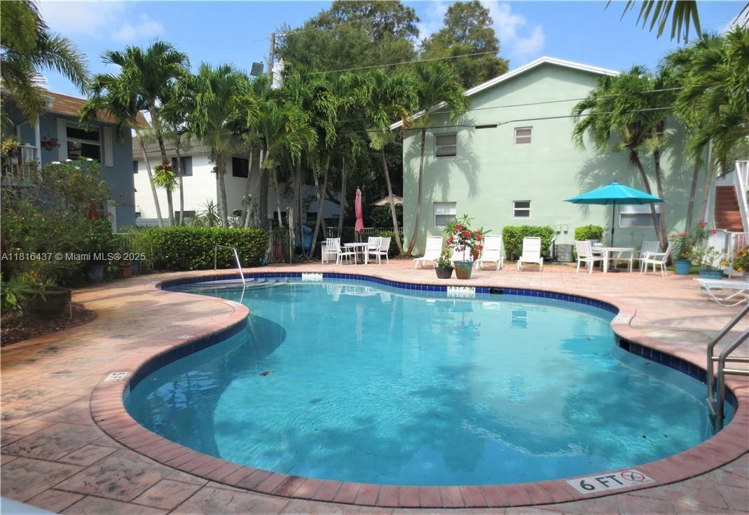 2607 Northeast 8th Avenue, Unit 19 Wilton Manors, FL 33334 - Photo 2 of 11 a view of a house with swimming pool