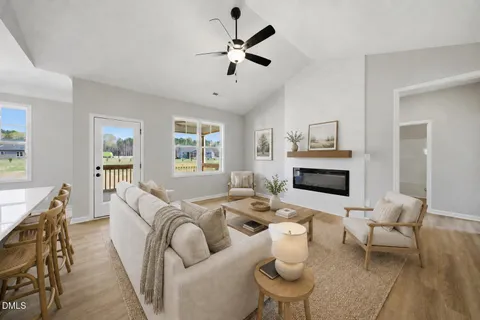 a living room with furniture a fireplace and a table