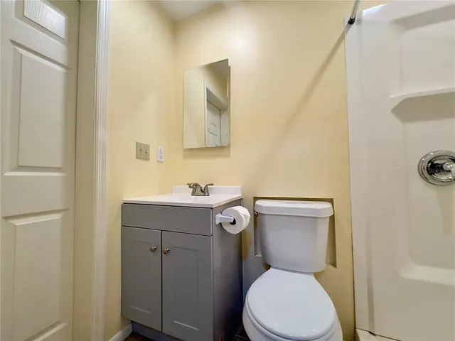 a white toilet sitting next to a bathroom sink