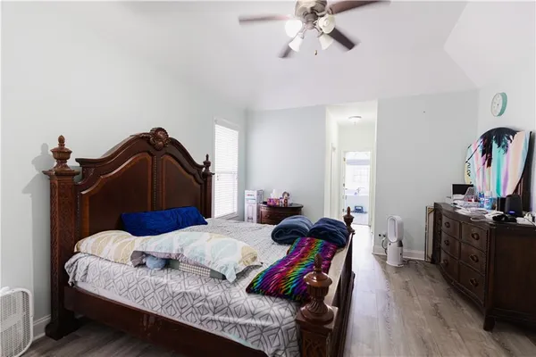 a bedroom with a bed and wooden floor