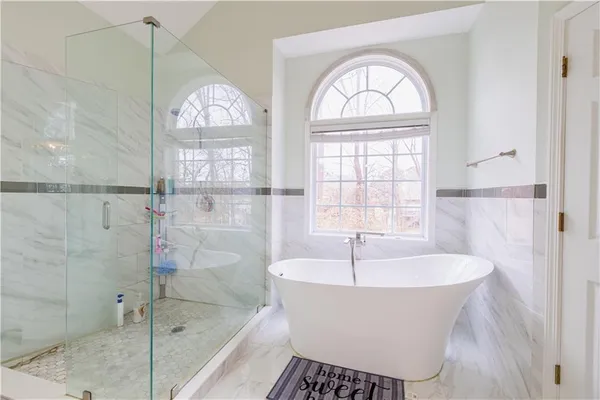 a white bath tub sitting next to a window