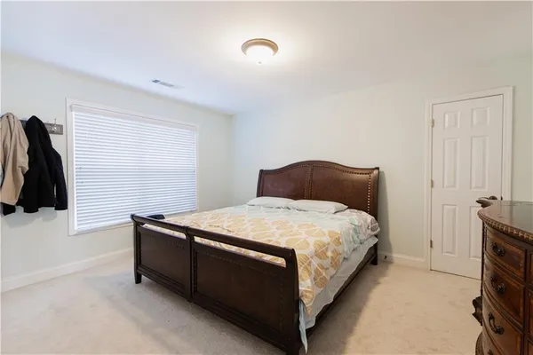 a bedroom with a bed and a walk in closet