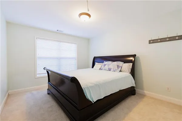 a bed sitting in a bedroom next to a window