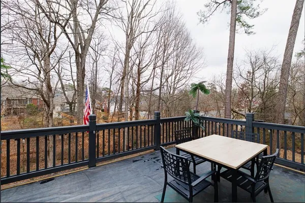 a view of a deck with furniture and trees