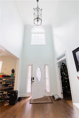 a view of a hallway with wooden floor and staircase