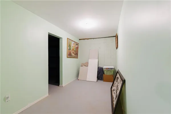 a view of storage and utility room with refrigerator and mirror