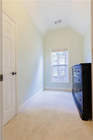 a spacious bedroom with a bed and a window