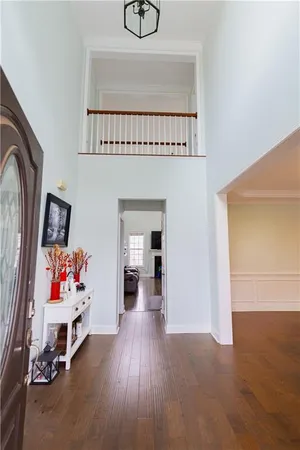 a living room with furniture and a baby crib