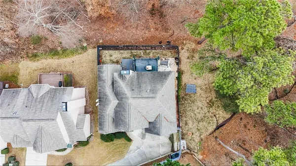 an aerial view of a house with a yard and large tree