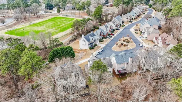 an aerial view of a house with a yard and lake view