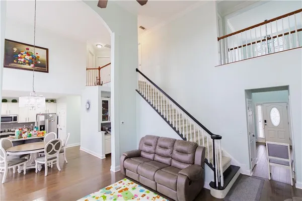 a bedroom with furniture and a wooden floor