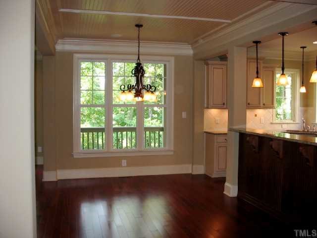 2820 Peachleaf Street Raleigh, NC 27614 - Photo 3 of 12 a view of an empty room with wooden floor and a window