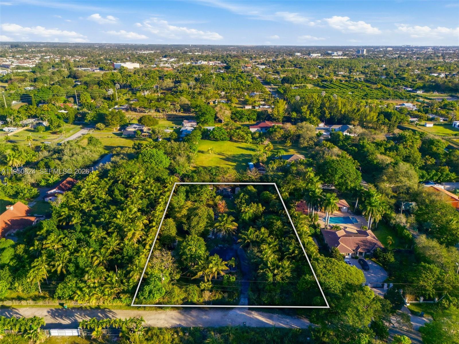 12325 Southwest 240th Street Homestead, FL 33032 - Photo 3 of 11 an aerial view of residential houses with outdoor space and trees